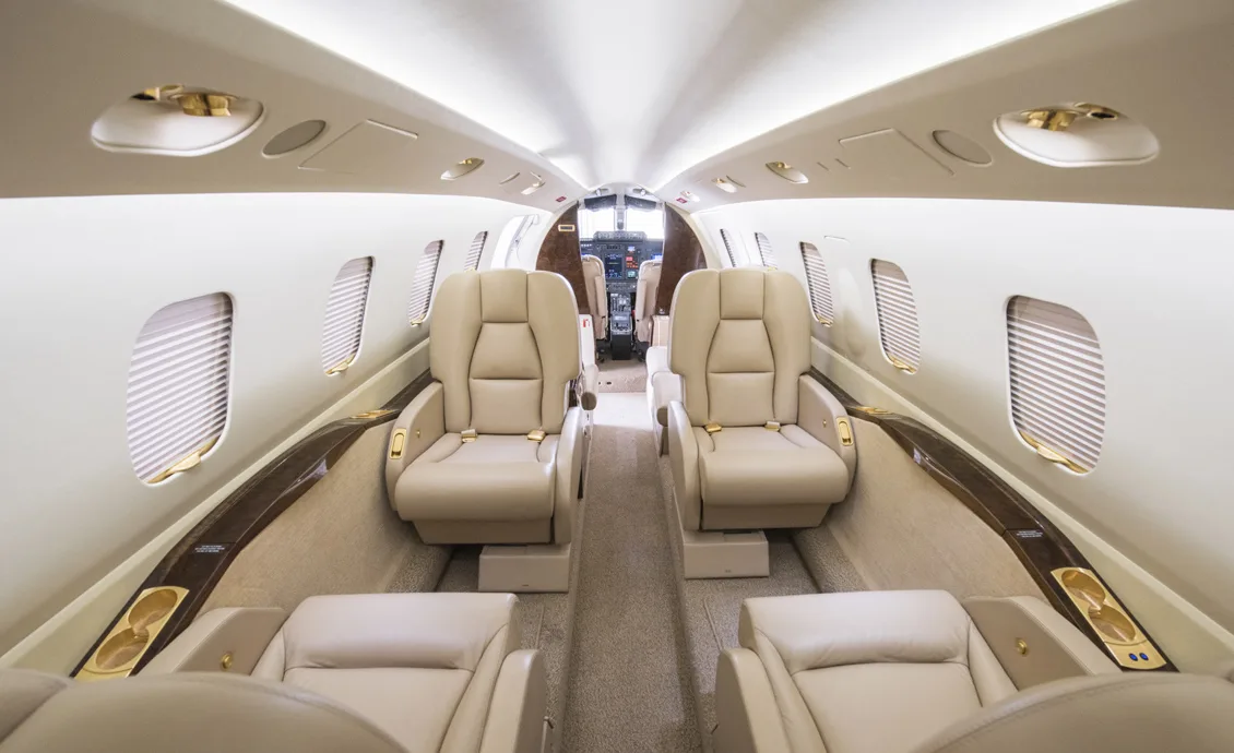 Forward view of the cabin with tan leather seats.