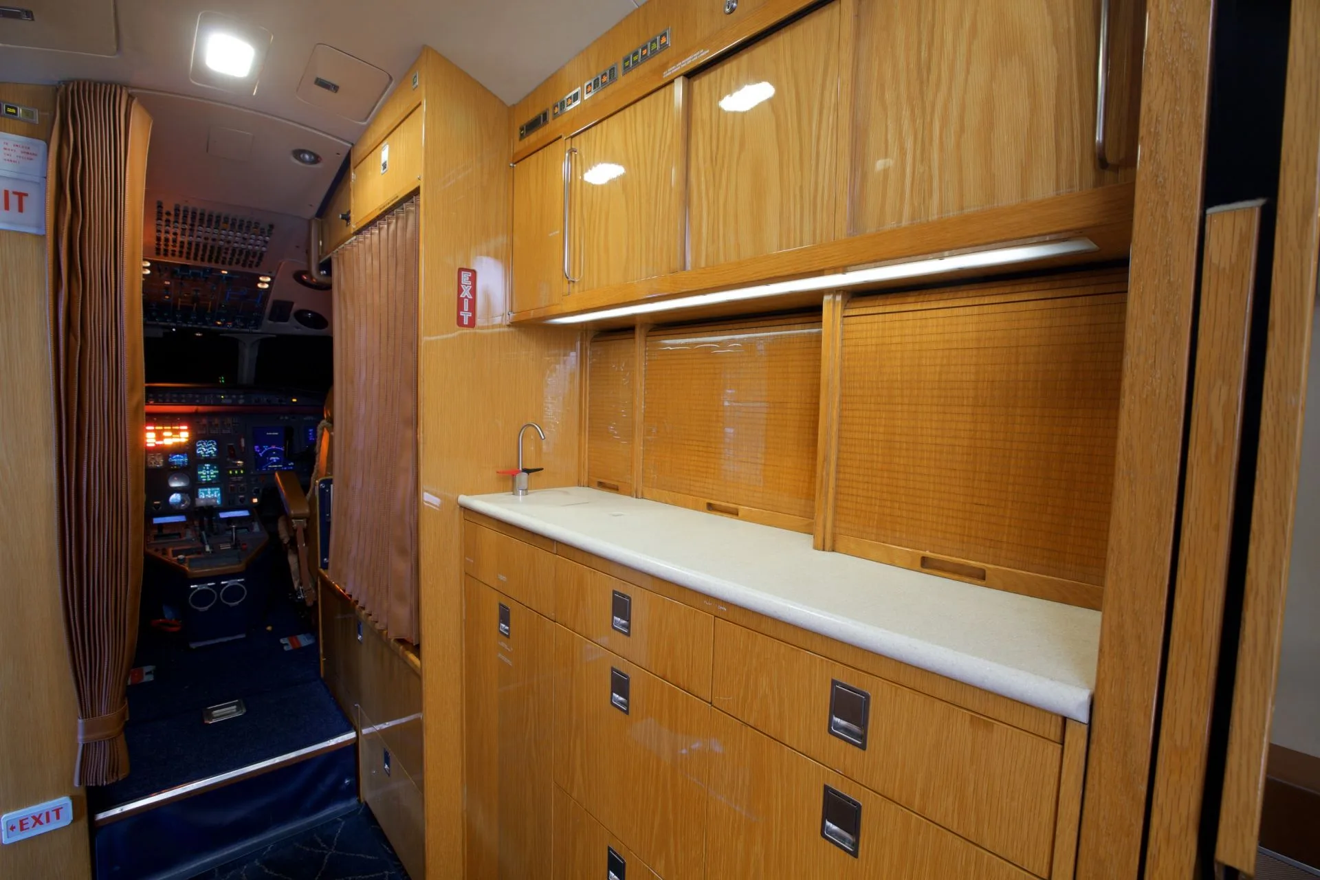 A view of the aircraft interior, including a sink and storage area.