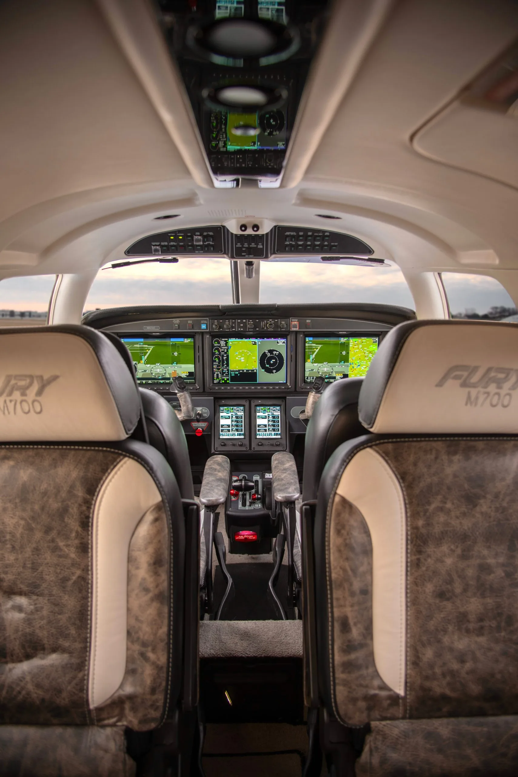 The cockpit of the Fury M700 aircraft with leather seats.