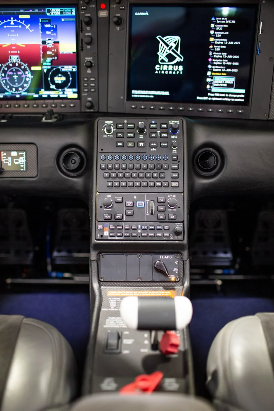Detailed view of the Cirrus SR20 central control panel and throttle quadrant.