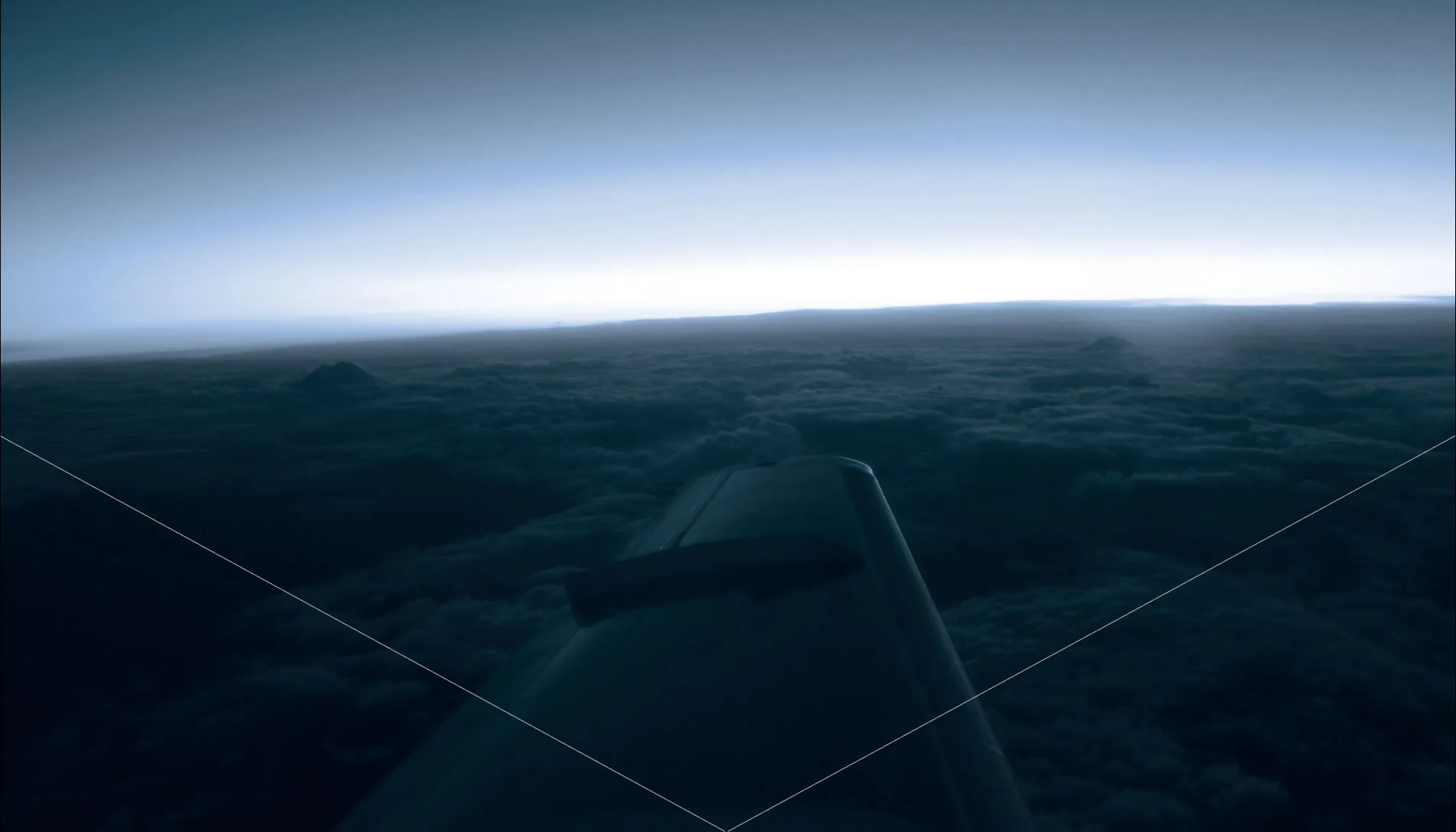 View of the wing of an aircraft flying over a cloudscape.