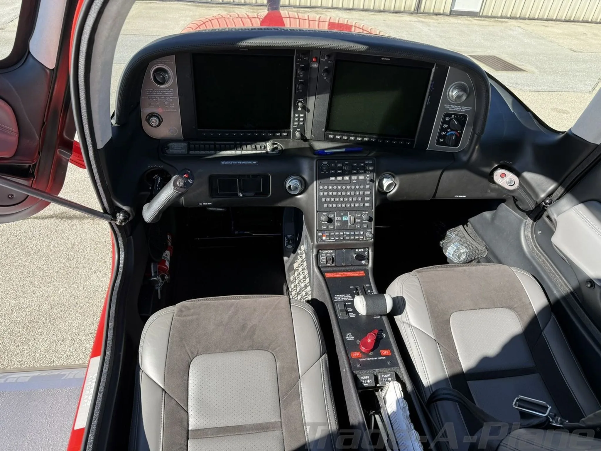 The cockpit of the Cirrus SR22T, featuring two large display screens and a central control panel.