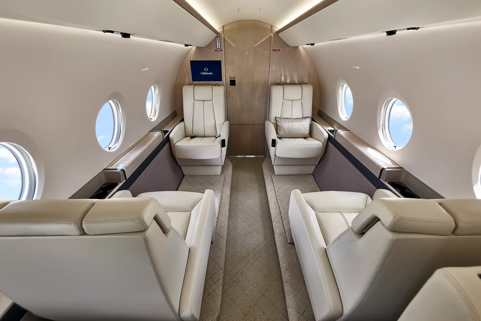 Forward view of the aircraft interior with white leather seats.