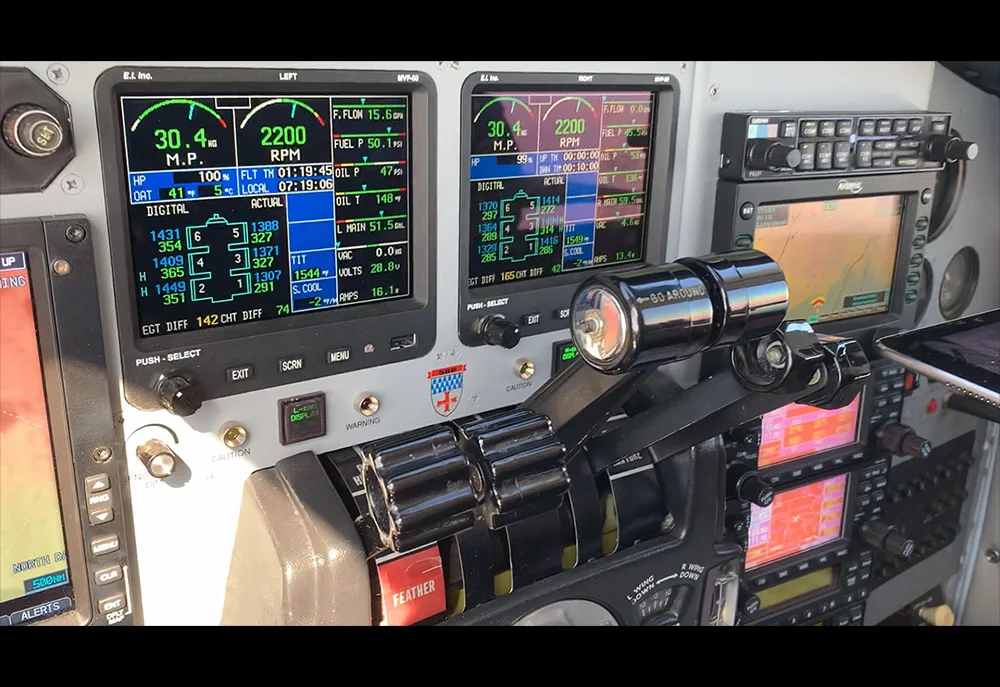 A view of the engine instrument displays and throttle quadrant in the cockpit.