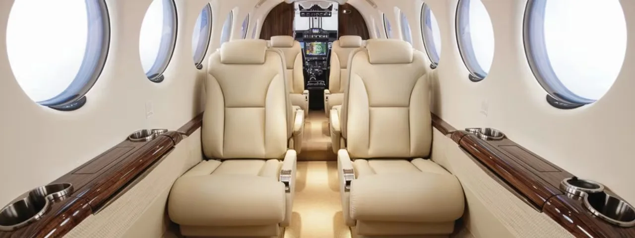Aircraft interior with leather seats and wood trim.