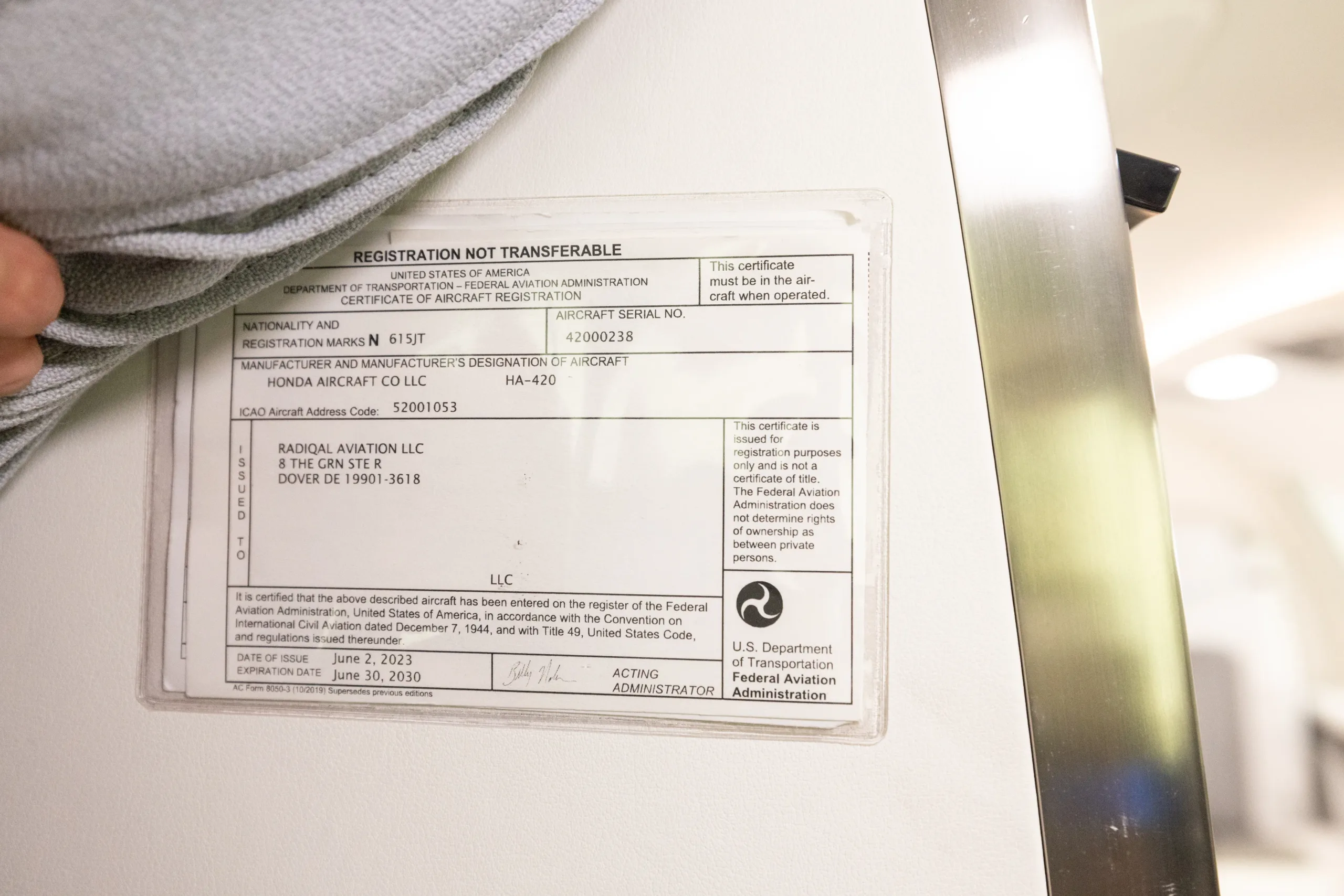 A close-up view of an aircraft registration certificate for N615JT, a HondaJet HA-420.
