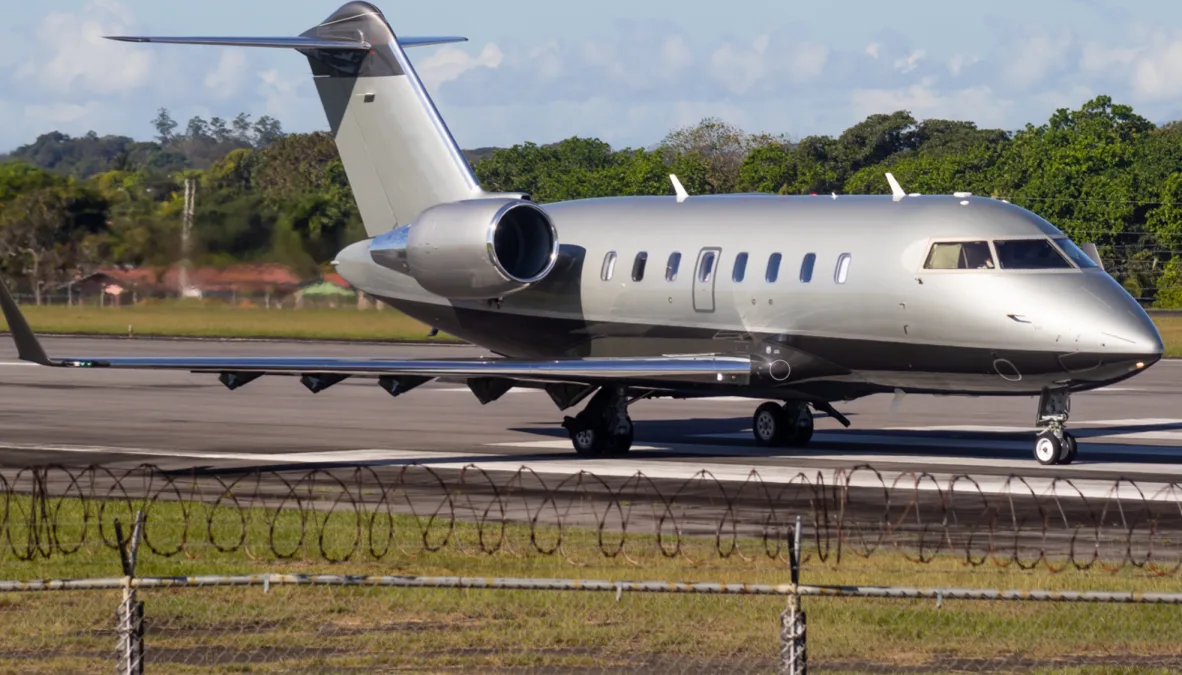 A grey Bombardier Challenger business jet on a runway.