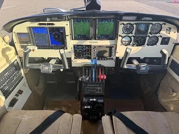 The cockpit features a modern glass panel with dual displays, traditional gauges, and yokes, with the aircraft registration N4506N visible on the panel.