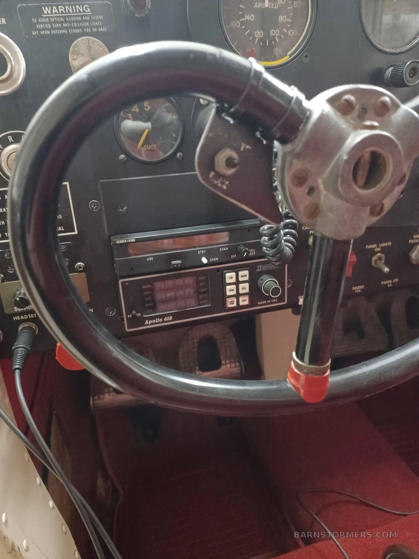 A close-up view of the aircraft's instrument panel showing the radio, a yoke, and various gauges.