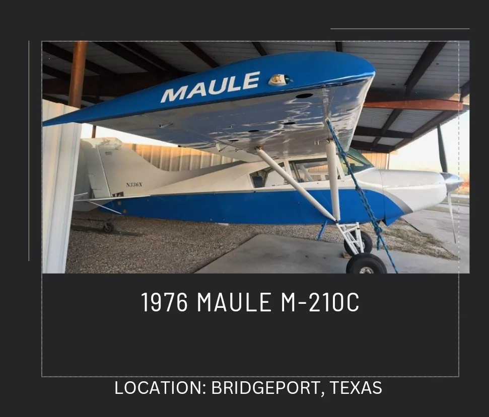 A blue and white 1976 Maule M-210C aircraft, N336X, parked in a hangar.