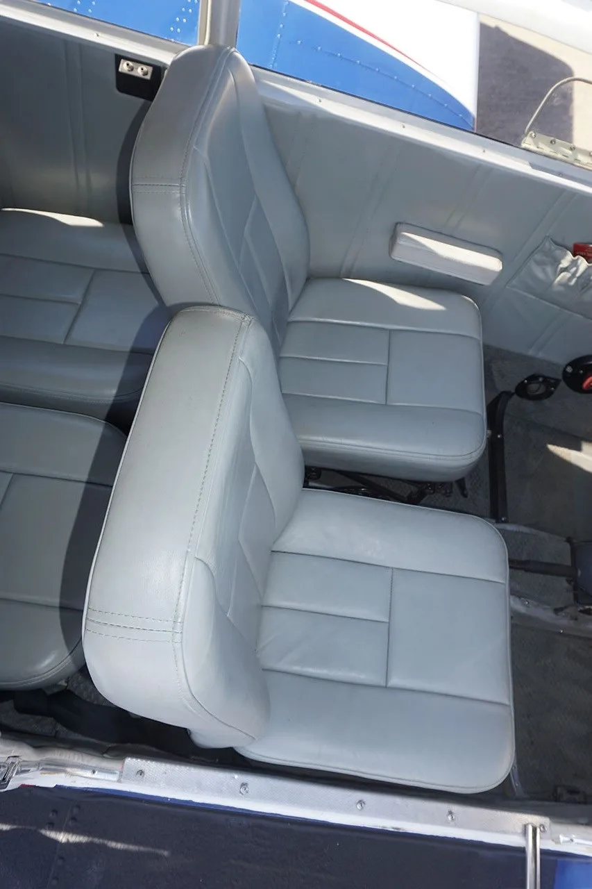 The light gray leather interior seats of the aircraft cabin.