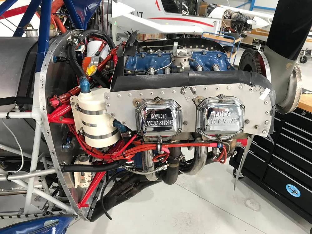 A close-up view of the exposed AVCO Lycoming engine of the N99AK biplane.