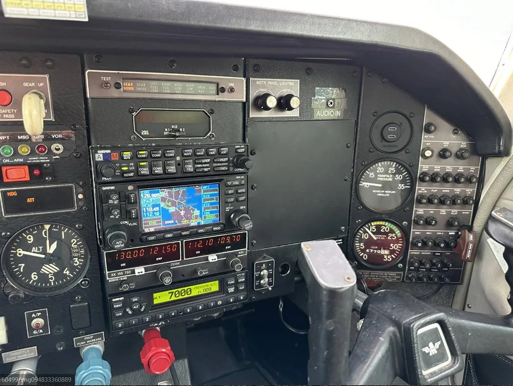 A close-up view of the Mooney M20J's avionics stack, including Garmin GPS/COM units.