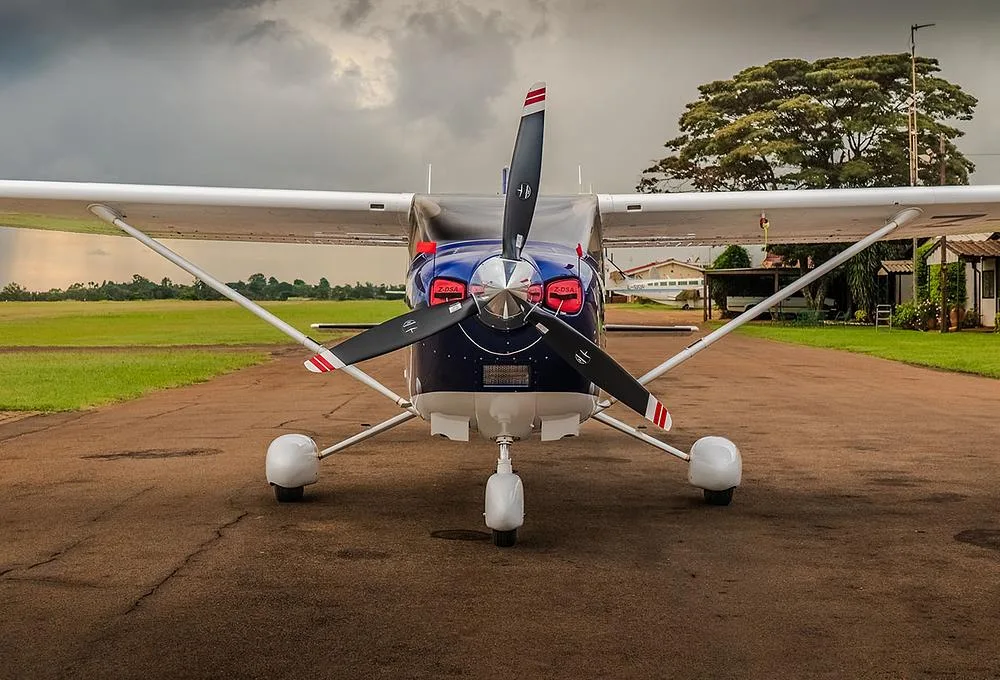 A head-on view of a blue and white Cessna Skylane (Z-DSA) parked on a tarmac.