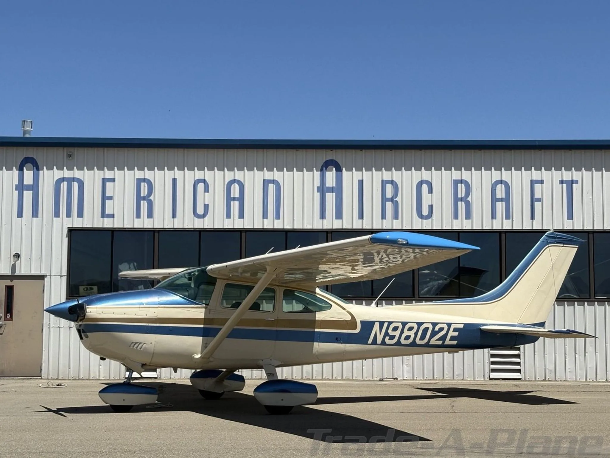 Side view of the Cessna 182P Skylane at an airport.