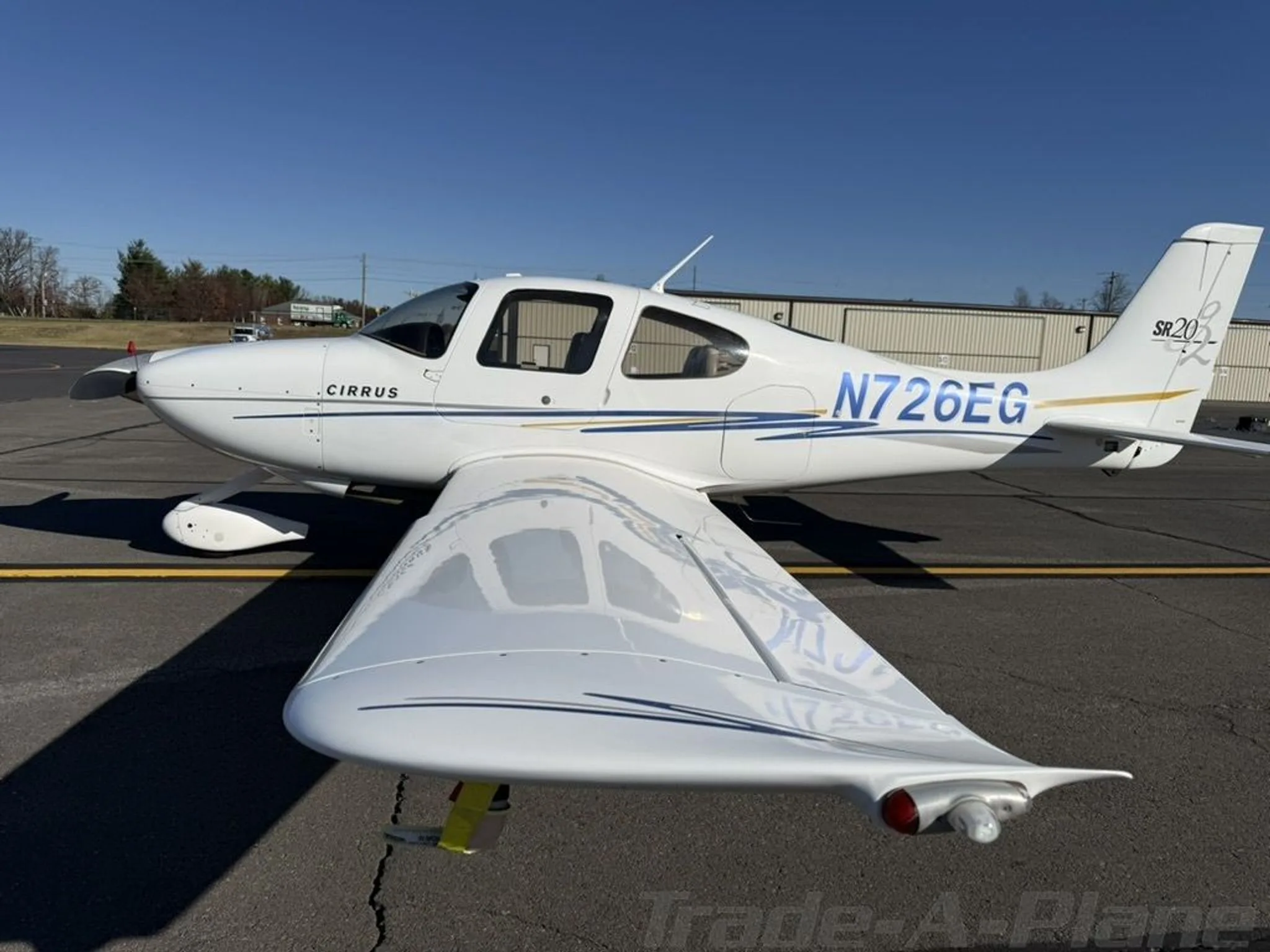 Side view of the Cirrus SR20-G2 parked.
