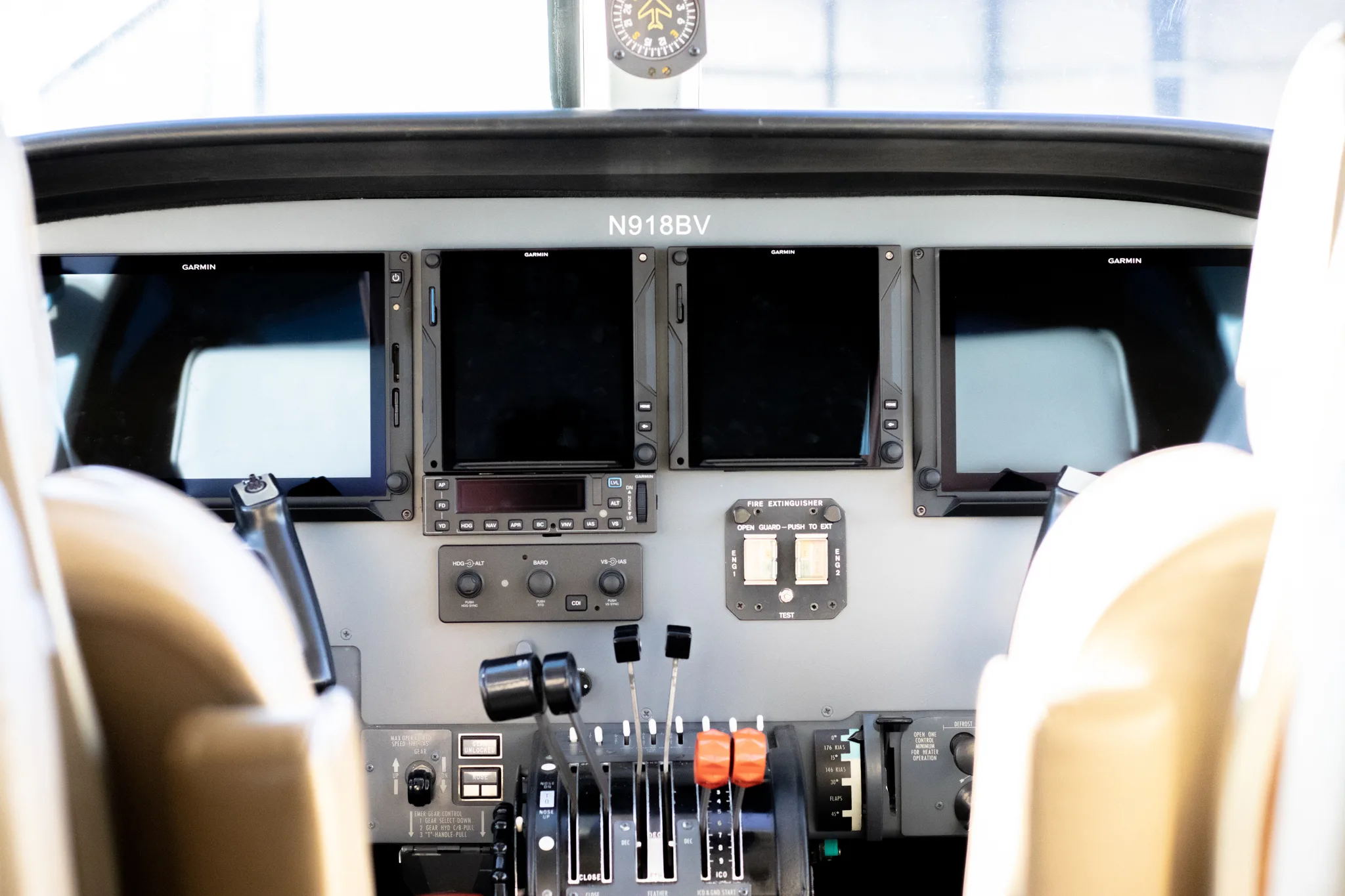 Aircraft cockpit instrument panel with Garmin displays.