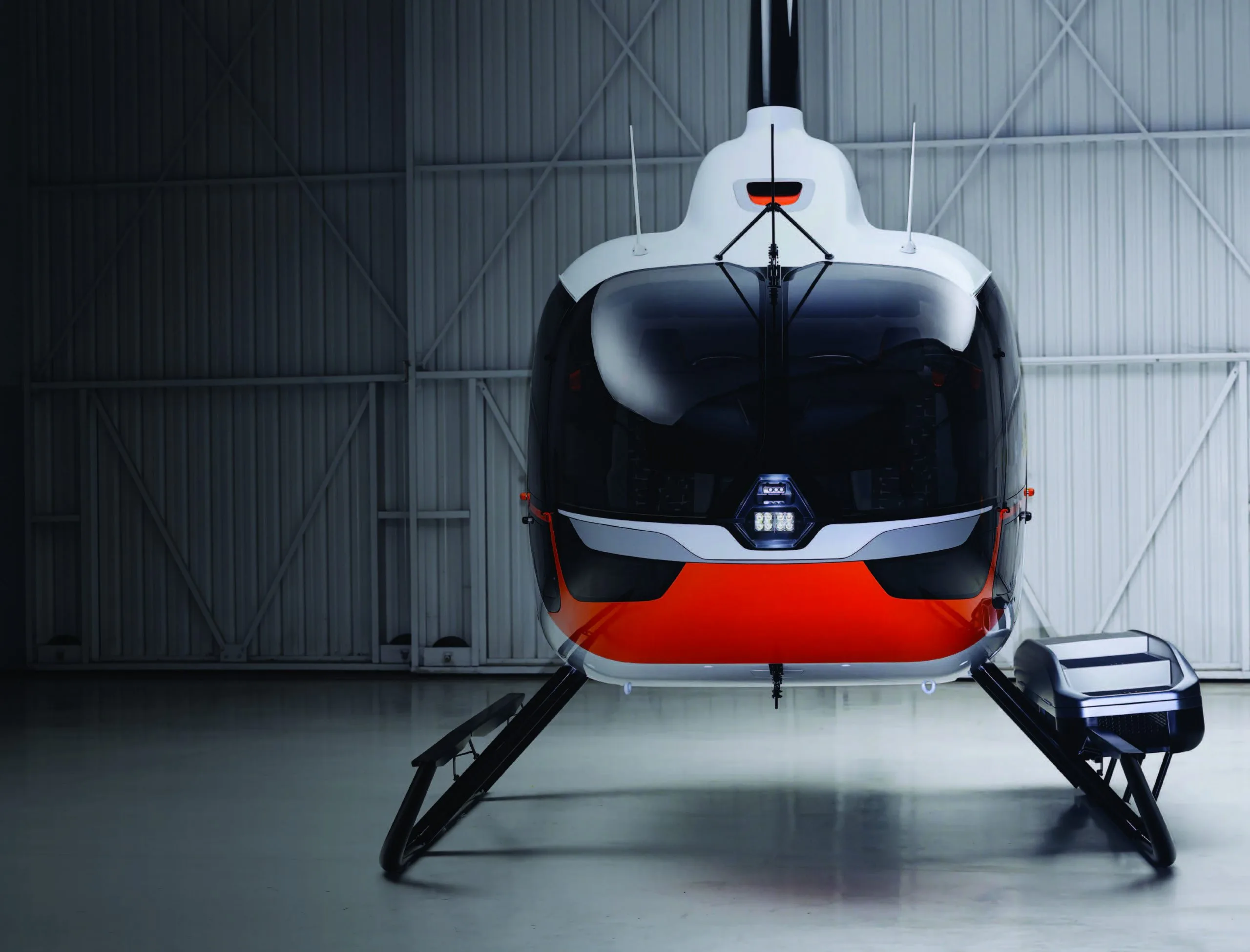 Front view of a Robinson helicopter in a hangar.