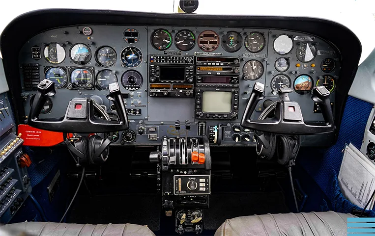 The cockpit of a Piper PA-34 Seneca aircraft, showing the instrument panel and controls.