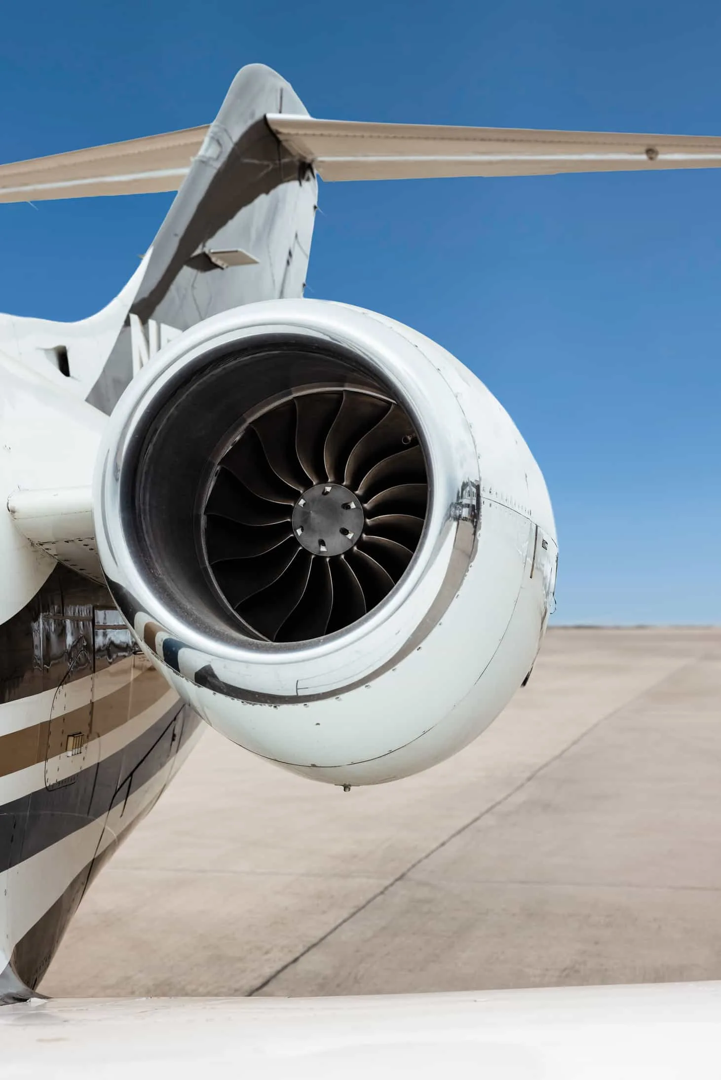 A close-up view of the jet engine on the private aircraft, showing the turbine blades.