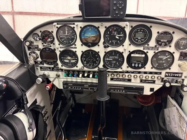 The instrument panel of the Aviat Husky A-1B, featuring analog gauges and a central control stick.