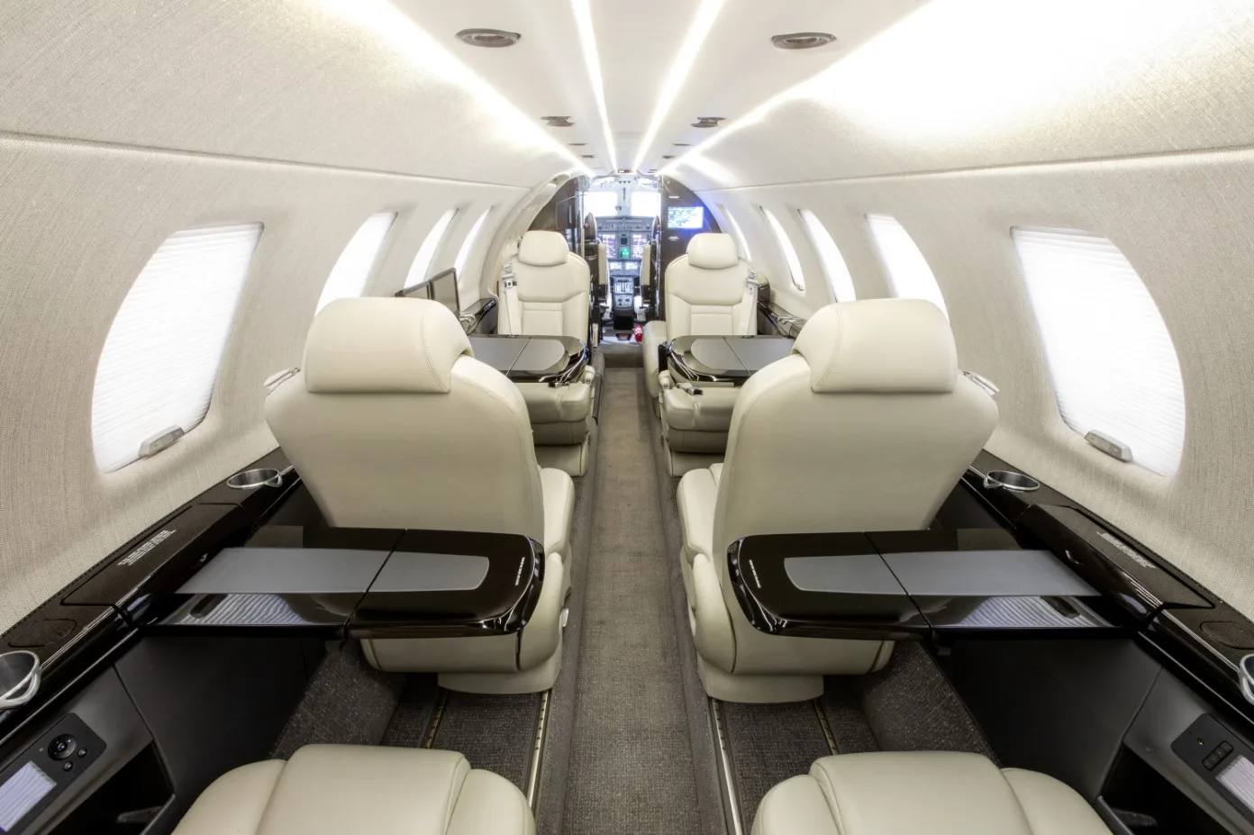 A view of the aircraft's interior, showing the seating arrangement and tables.