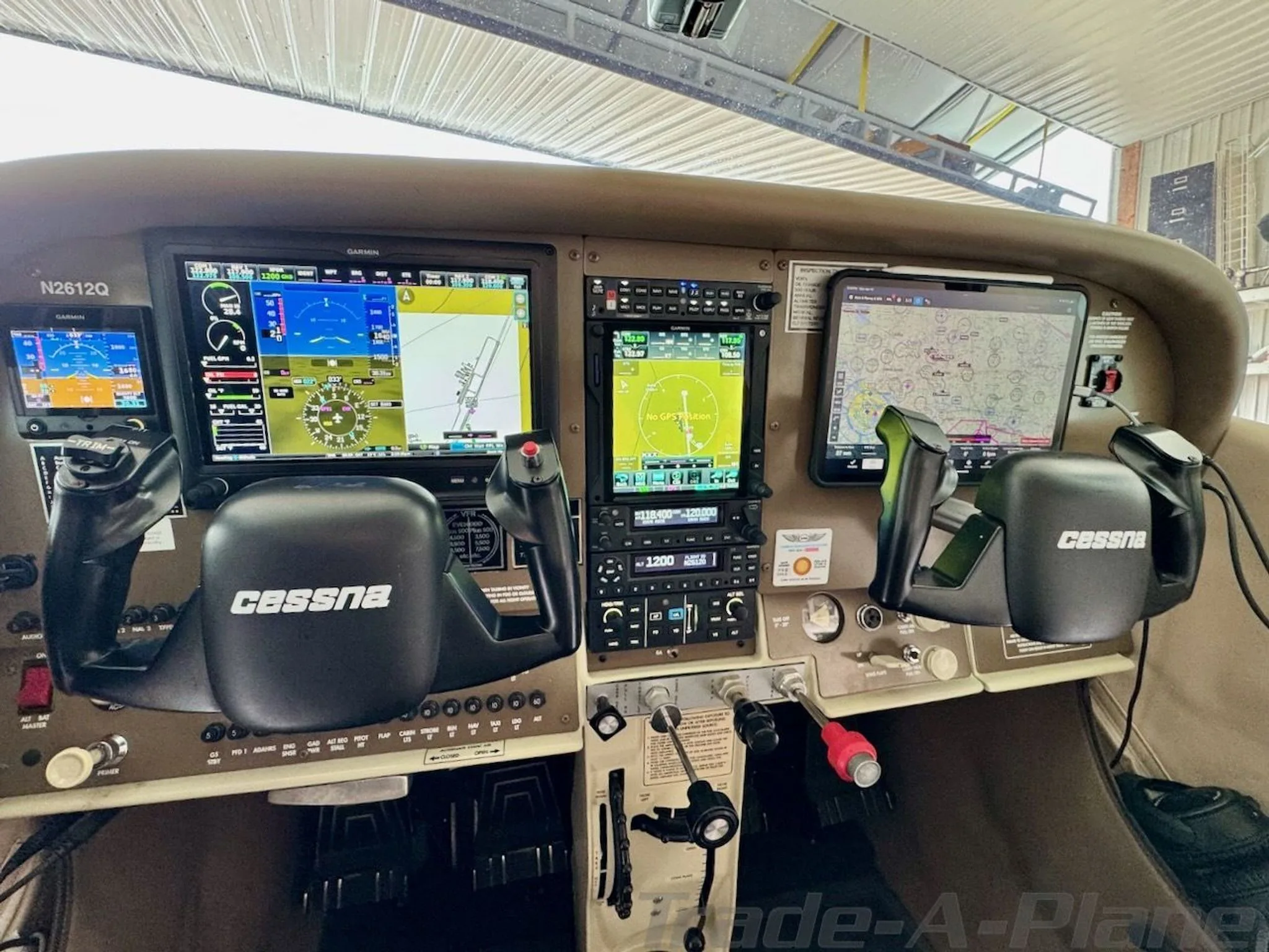 A detailed view of the Cessna N2612Q cockpit with modern Garmin avionics and controls.