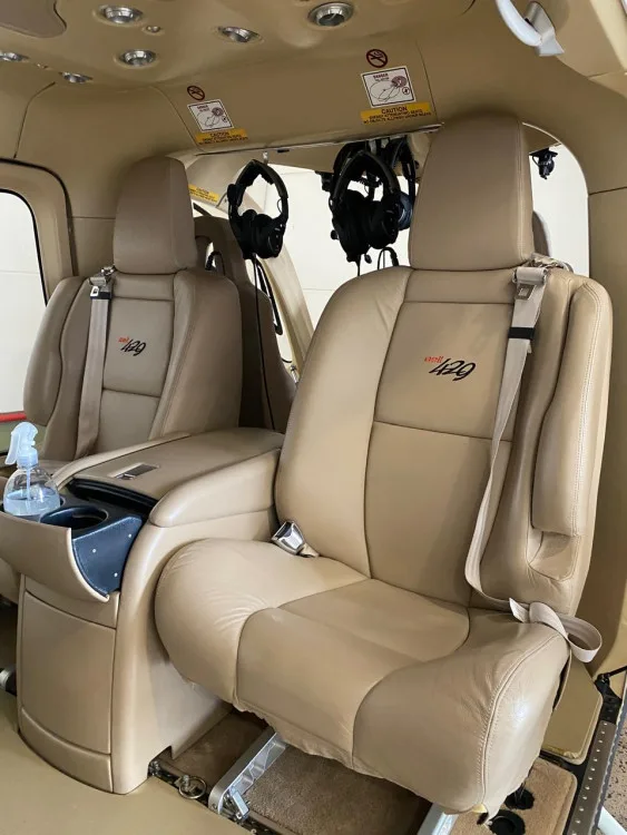 A close-up of two tan leather passenger seats with "429" embroidery in the Bell 429 helicopter interior.