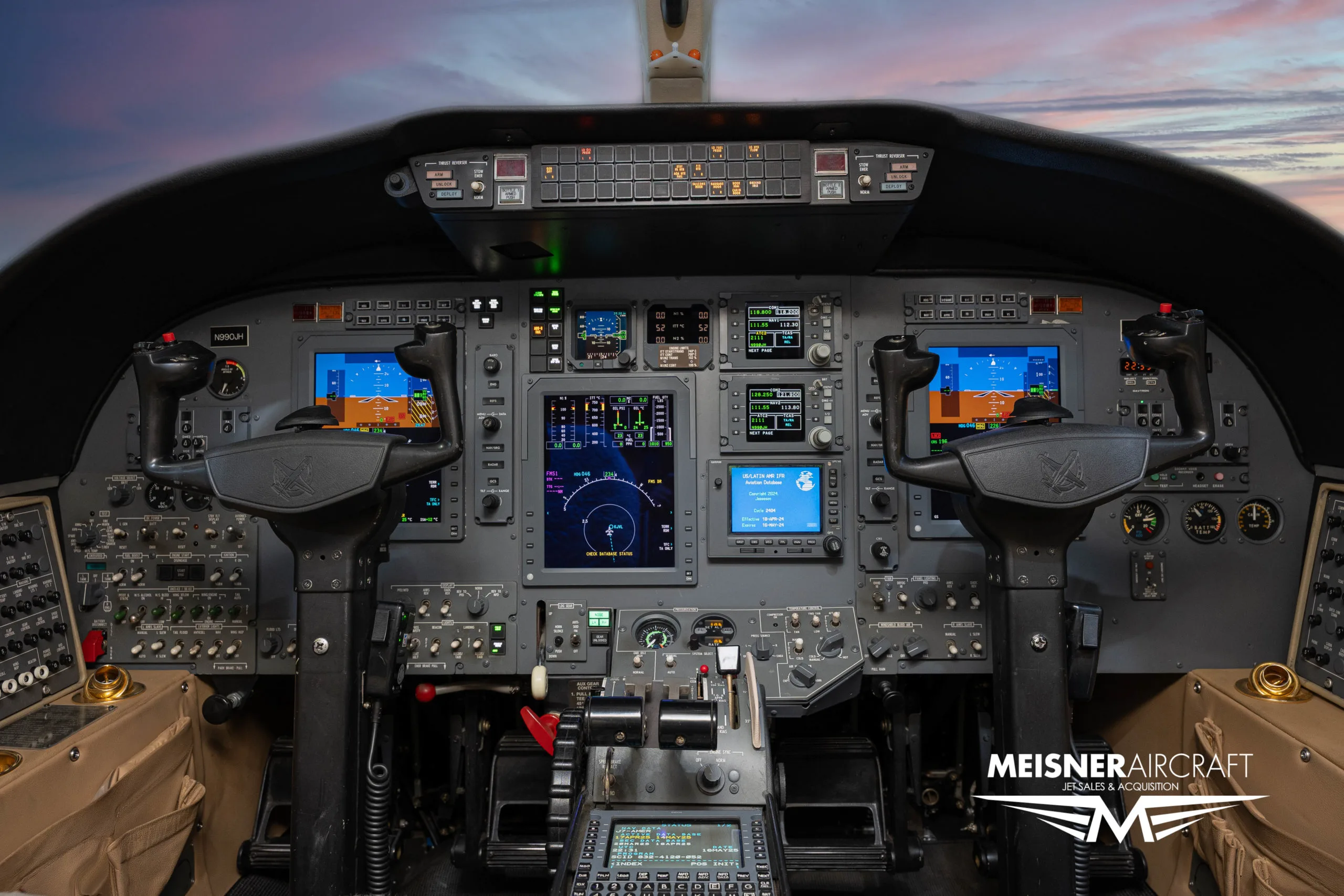 The cockpit of a Cessna Citation jet, showing multiple digital displays and control yokes.