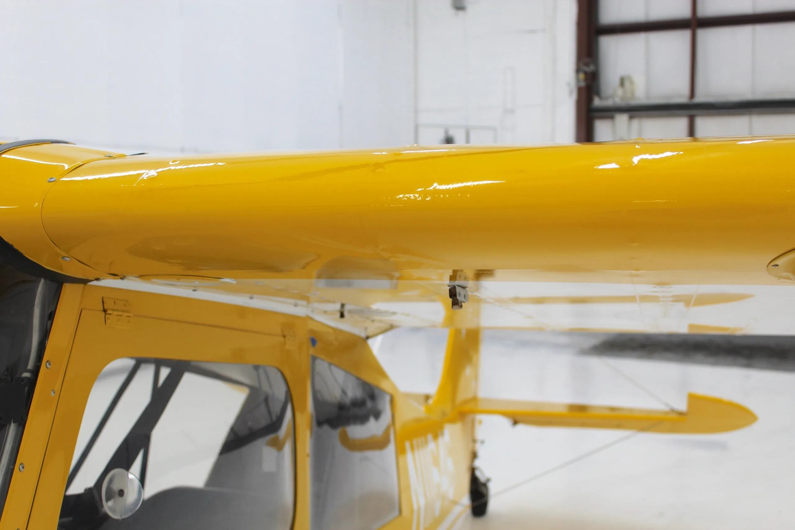 An overhead view of the yellow wing and upper fuselage of the N11646 aircraft.