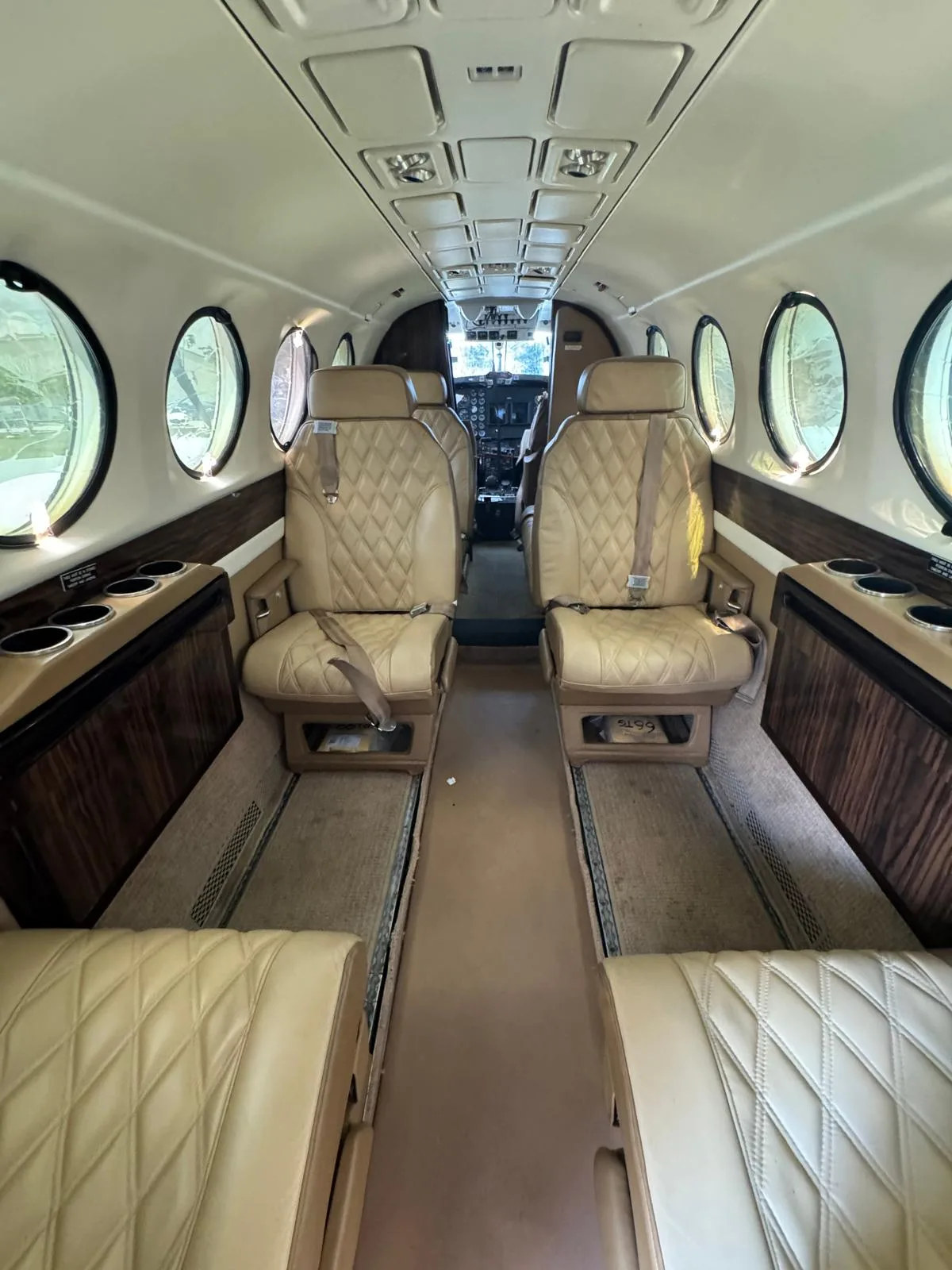 Interior view of the King Air 200 cabin with tan leather seats.