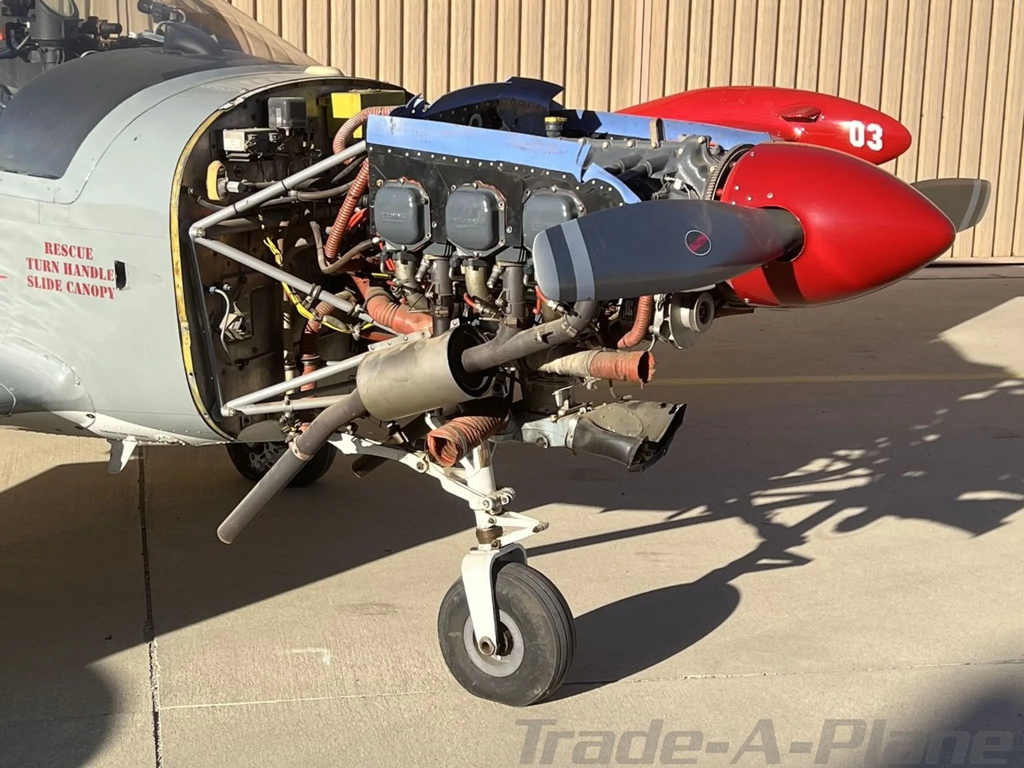 A close-up view of the exposed engine and propeller of the N13FD aircraft, showing mechanical details.