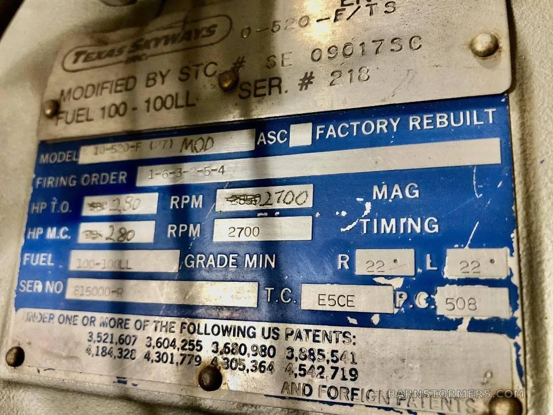 A close-up of an aircraft engine data plate showing model, serial, and patent information.