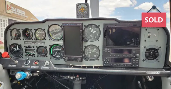 Close-up of the aircraft's instrument panel with various gauges and displays.