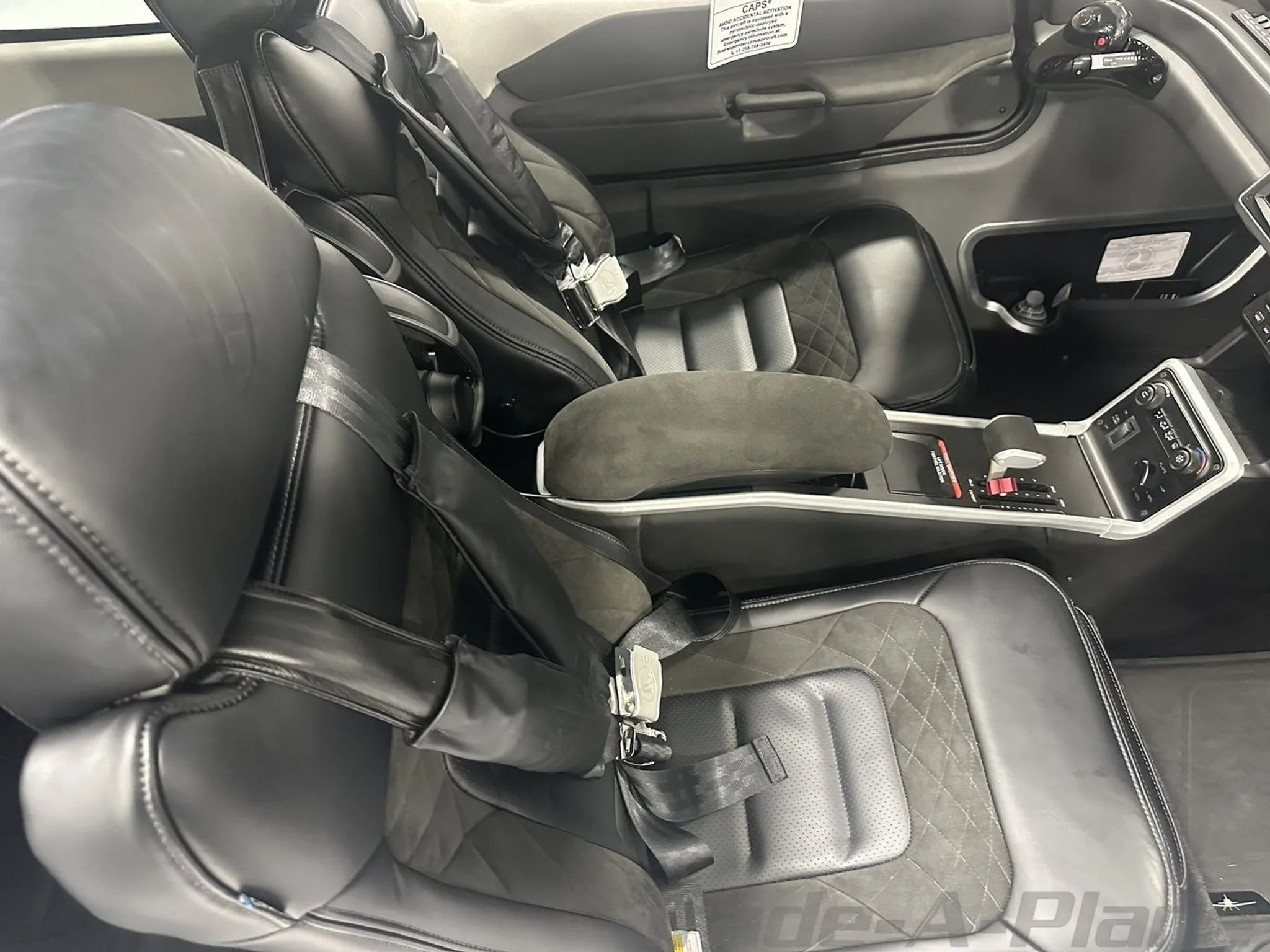 A close-up view of the aircraft's black leather interior seats with quilted stitching.