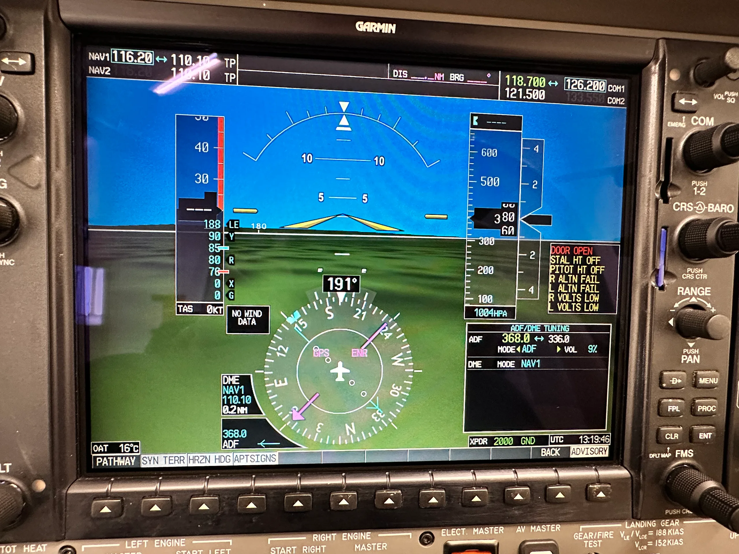 A close-up view of a Garmin G1000 display in an aircraft cockpit, showing flight data, attitude indicator, and navigation information.