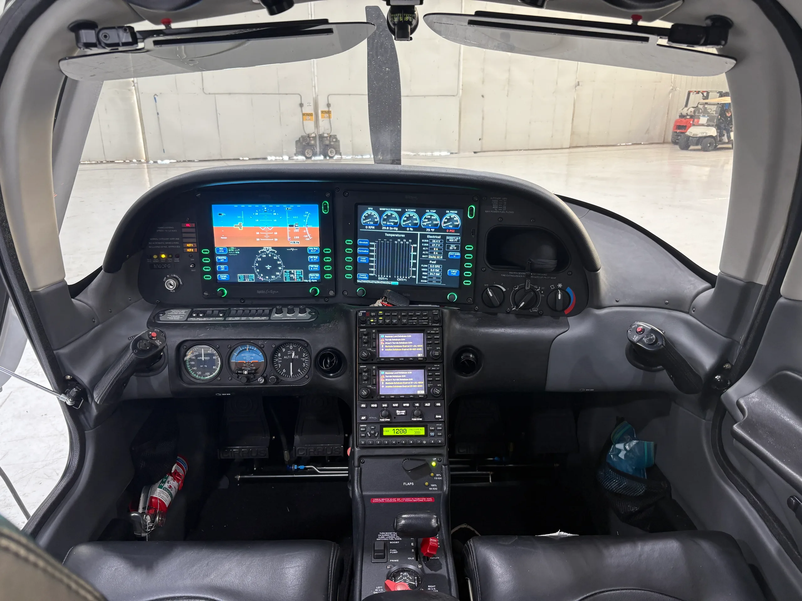 The cockpit of a Cirrus SR22 aircraft, featuring a glass panel display, viewed from the pilot's seat.