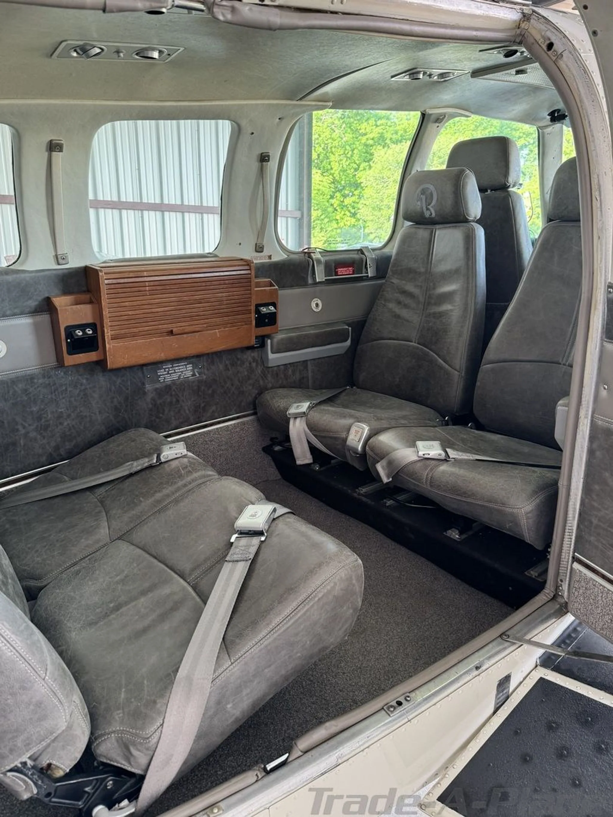 The gray leather interior cabin of the N185A aircraft, showing multiple passenger seats.