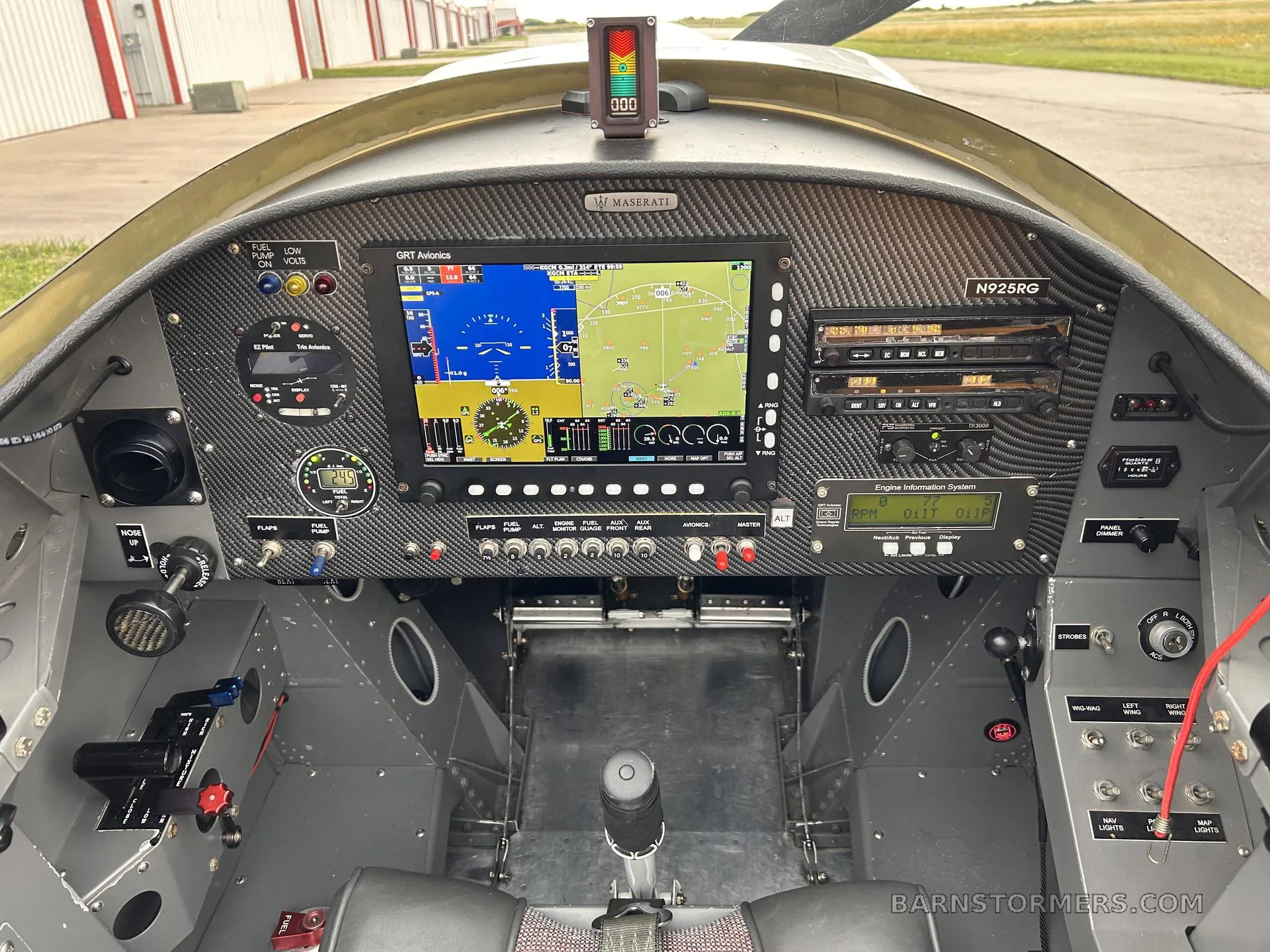The cockpit of a light aircraft, featuring a large digital display, various instruments, and controls.