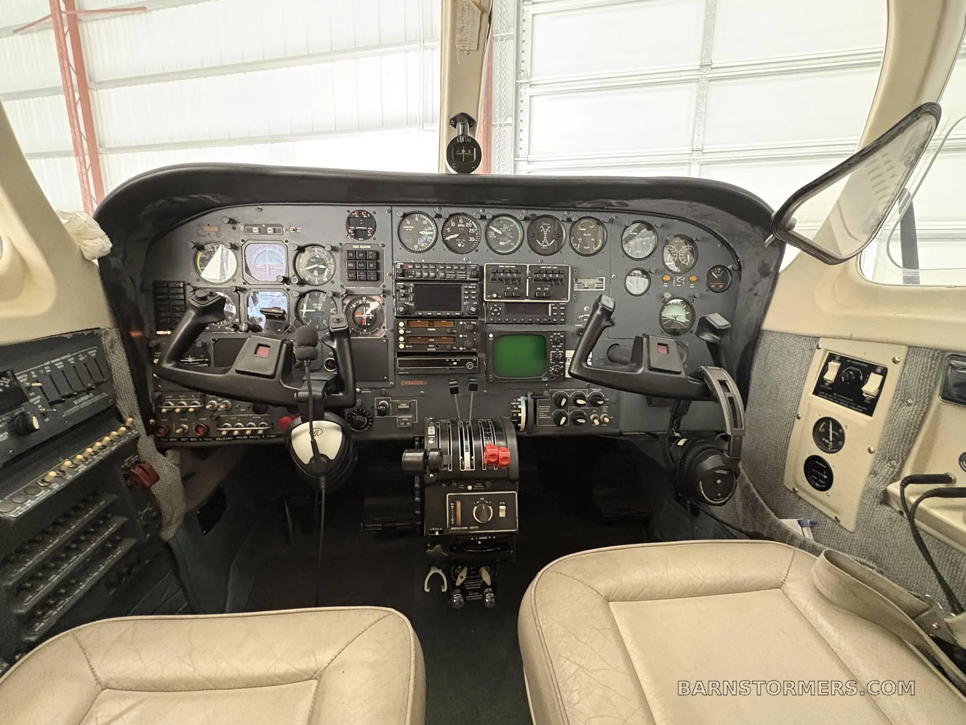 A detailed view of the aircraft's instrument panel with various gauges, radios, and controls.