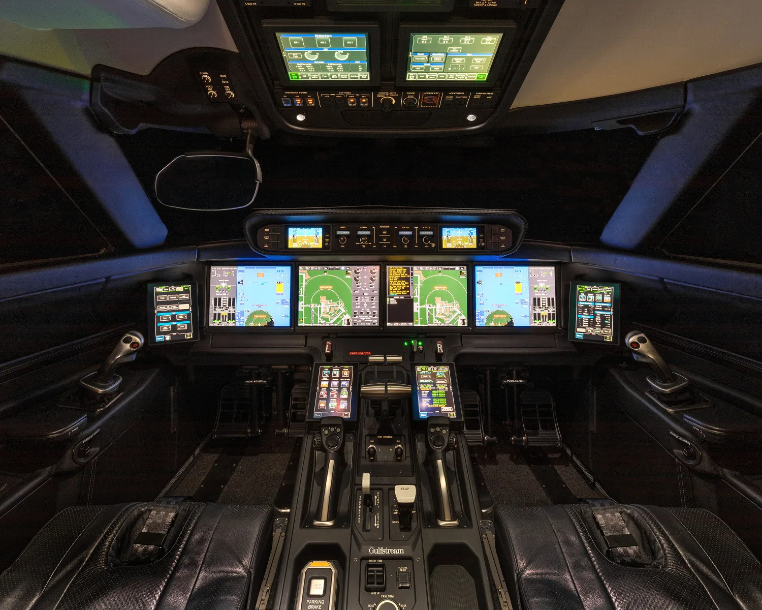 The cockpit of the aircraft features multiple display screens and controls.