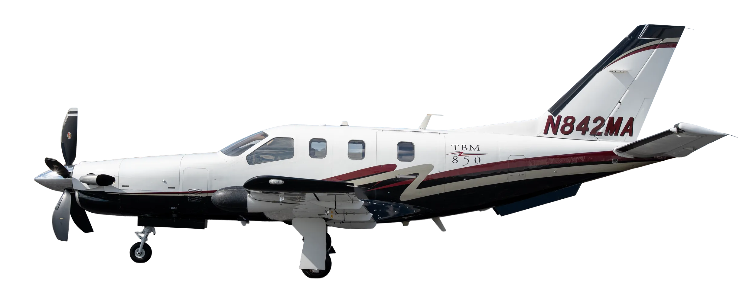 A white TBM 850 turboprop aircraft with black and red accent stripes, seen from the side against a clear sky.
