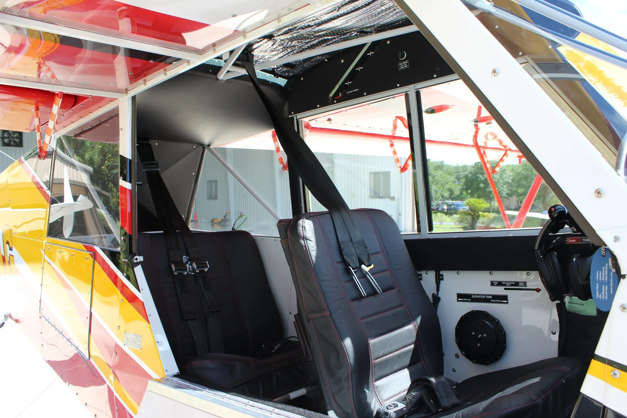 The black leather interior seats with red stitching inside the Aviat Aircraft Husky A-1C.
