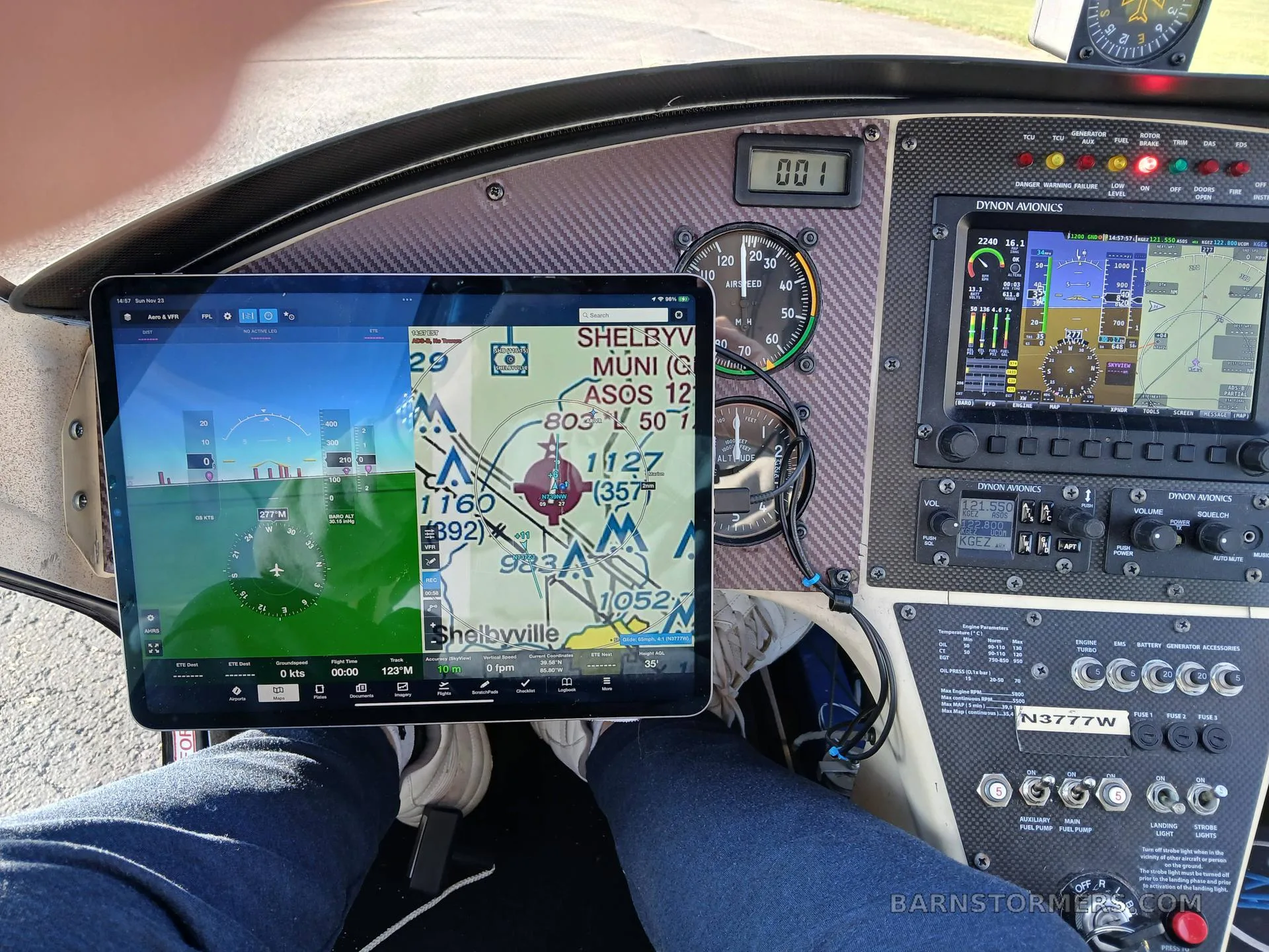The cockpit of a gyrocopter showing an instrument panel with a tablet displaying a navigation map and flight data.