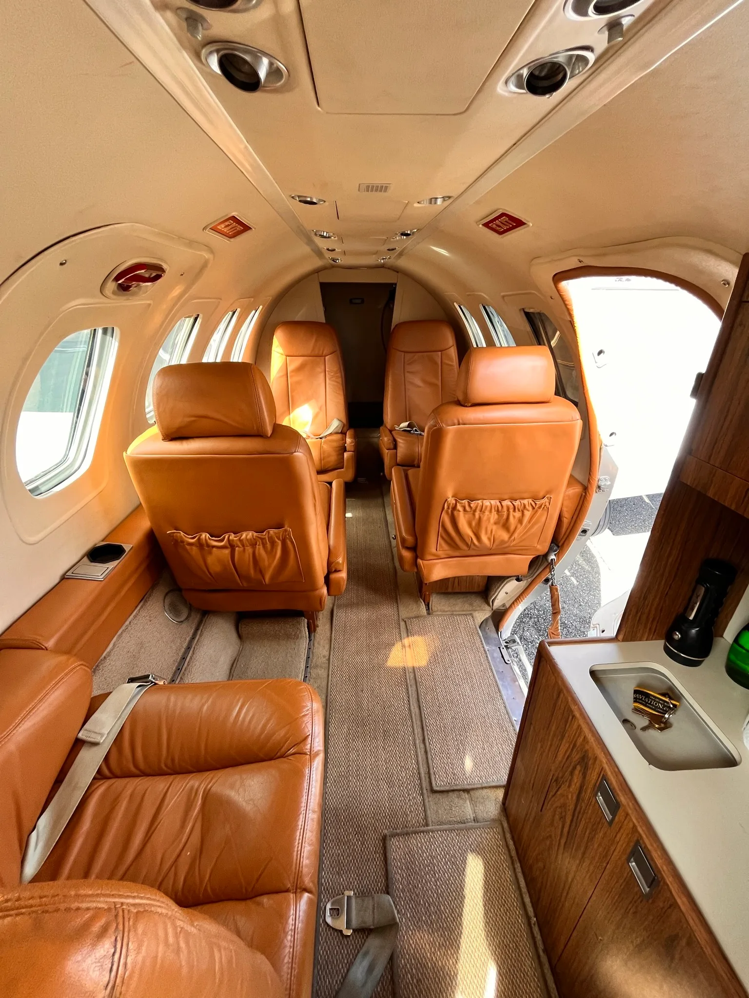 Interior view of the Cessna Citation Mustang cabin with tan leather seats.