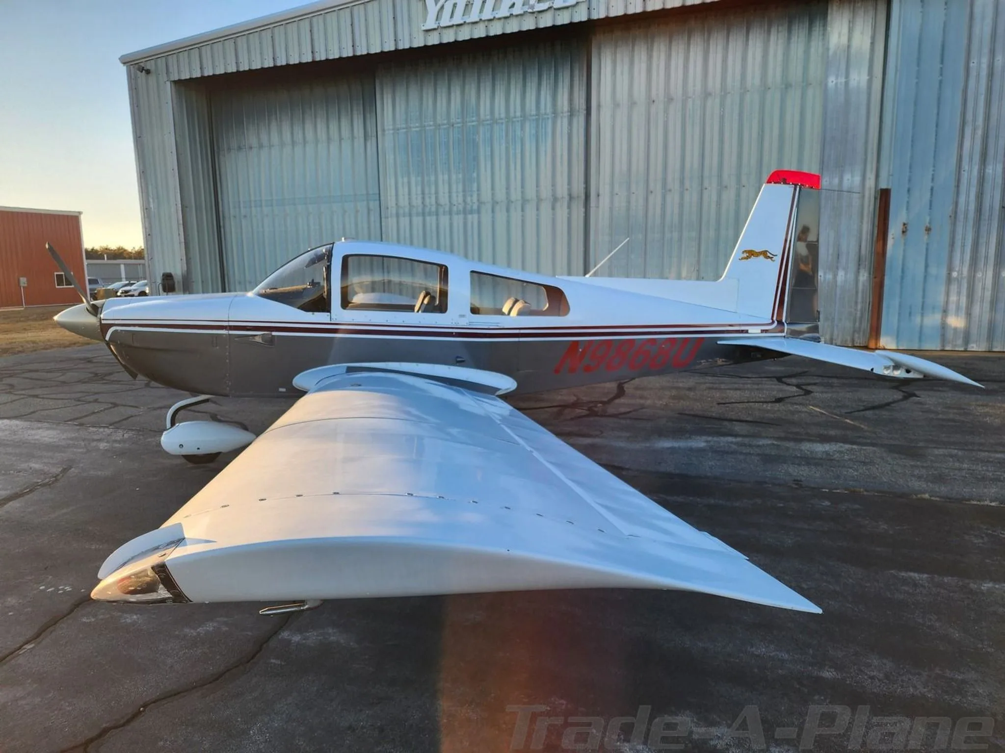 Another angle of the aircraft parked near the hangar.