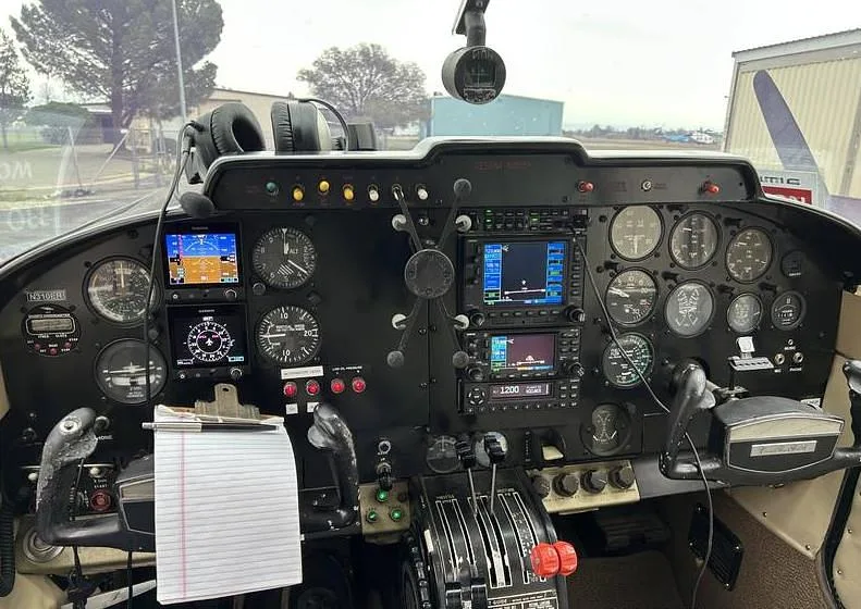 The aircraft's instrument panel featuring a mix of analog gauges and modern digital displays.