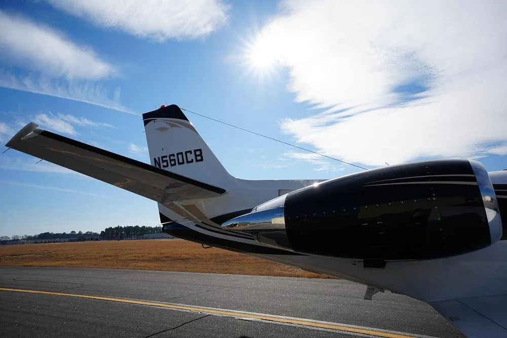 A close-up view of the tail and engine of the Cessna Citation Encore N560CB, showing the registration and black engine nacelle.