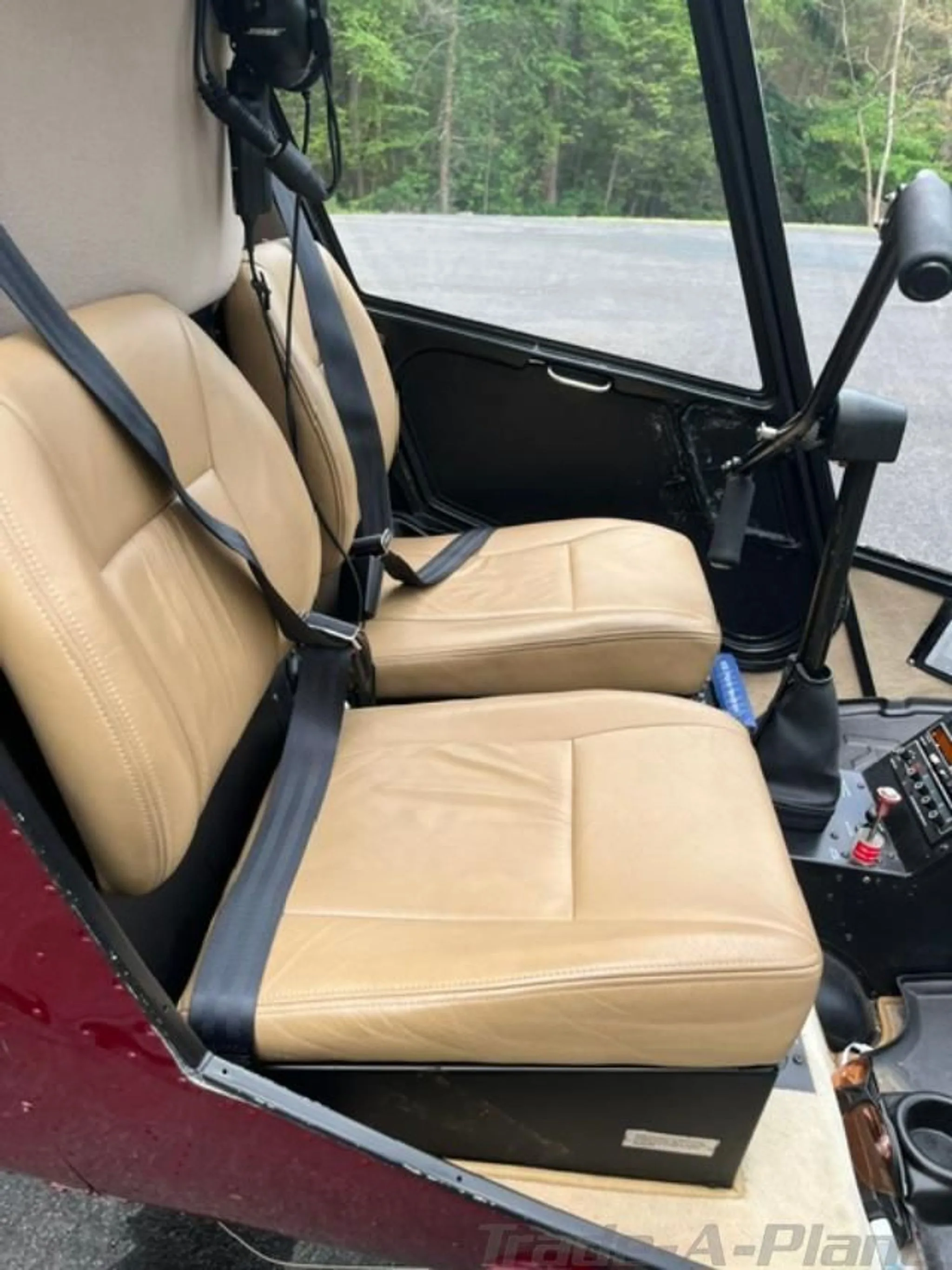 The tan leather seats and interior of a helicopter cabin.