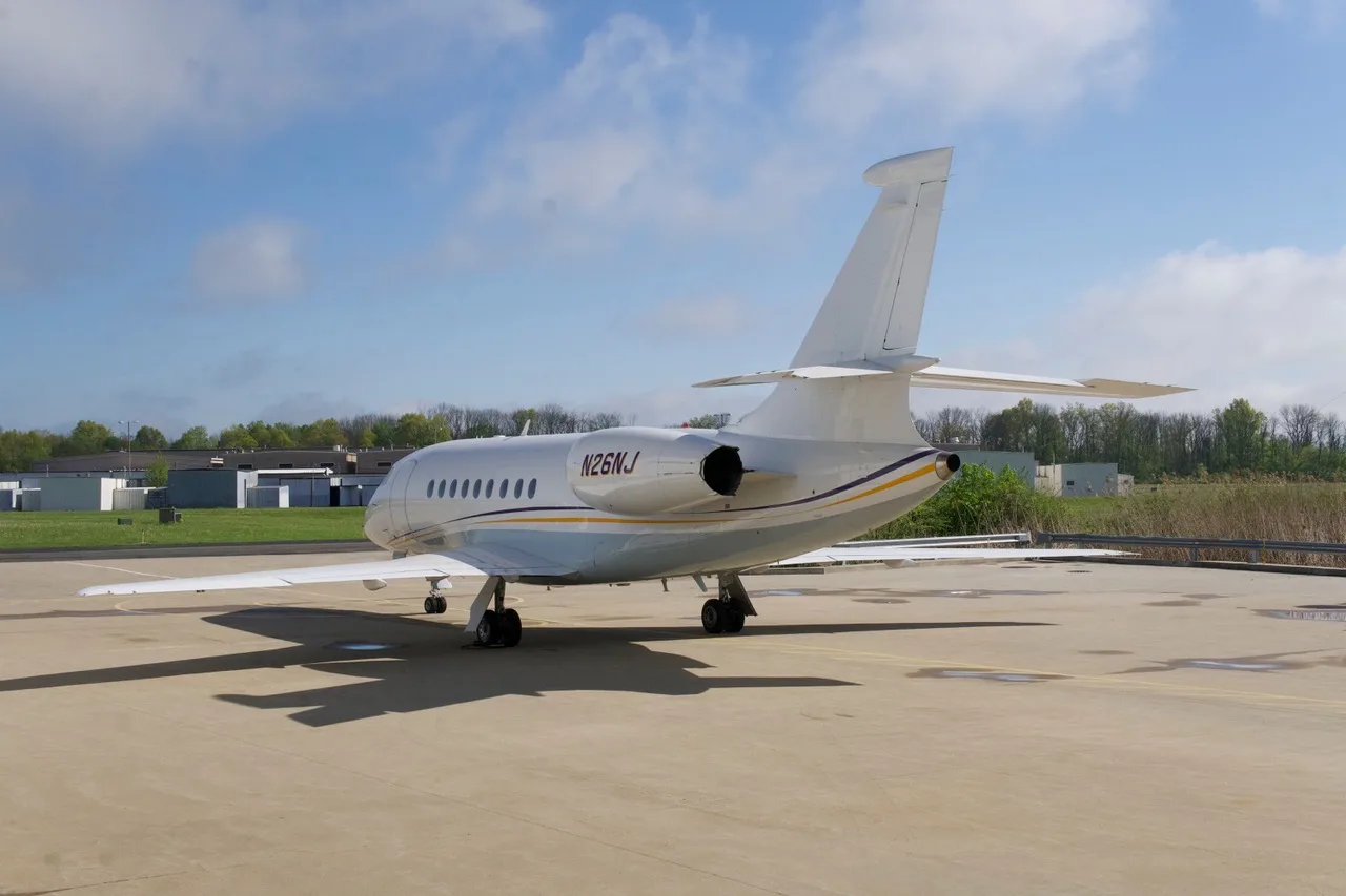 Rear view of the aircraft N26NJ parked on the tarmac.
